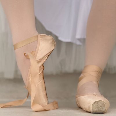 Close-up of feet in athletic shoes, poised to move on a clean floor.